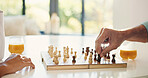Senior, hands and playing chess with nurse for board game, strategy or problem solving in home. Closeup, caregiver and elderly person with tactical move, attack or critical thinking in old age house