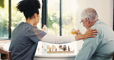 Buy stock photo Nurse, senior man and chess in home with cognitive wellness, juice and support with challenge in retirement. Elderly person, caregiver and play board game with brain function, drink and fun at house