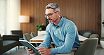 Reading, tablet and business man in office for finance review, investment and trading analyst. Professional, financial advisor and mature person on digital tech for stock market, research and profit