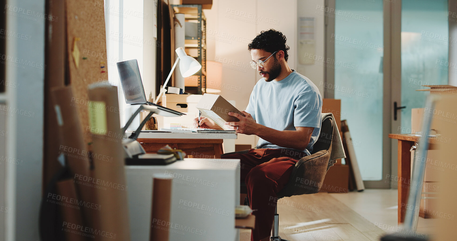 Buy stock photo Ecommerce, man and writing in office with box for customer order, shipping inspection or verification. Person, reading package or notes in workplace for logistics, quality control or courier service.