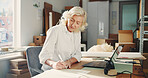 Logistics, notes or woman in office with paper, parcel track or inventory management of shipment. Distribution, mature person or entrepreneur with writing, order schedule or checklist in ecommerce.