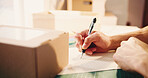 Writing, boxes and hands of person in office with logistics, distribution or cargo freight information. Pen, cardboard package and supply chain worker with parcel for delivery, ecommerce or shipping.