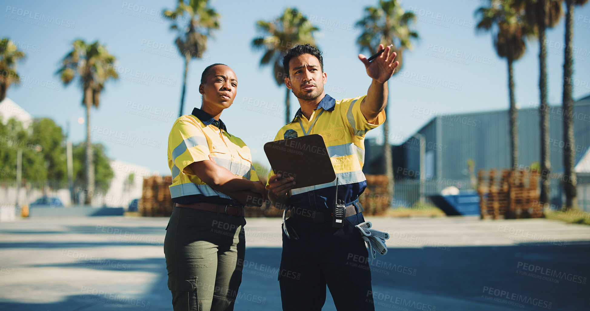 Buy stock photo Supply chain, coworkers and outdoor with clipboard for conversation, dispatch or shipping feedback. Logistics, people and point in cargo zone with checklist for discussion, export or quality control.
