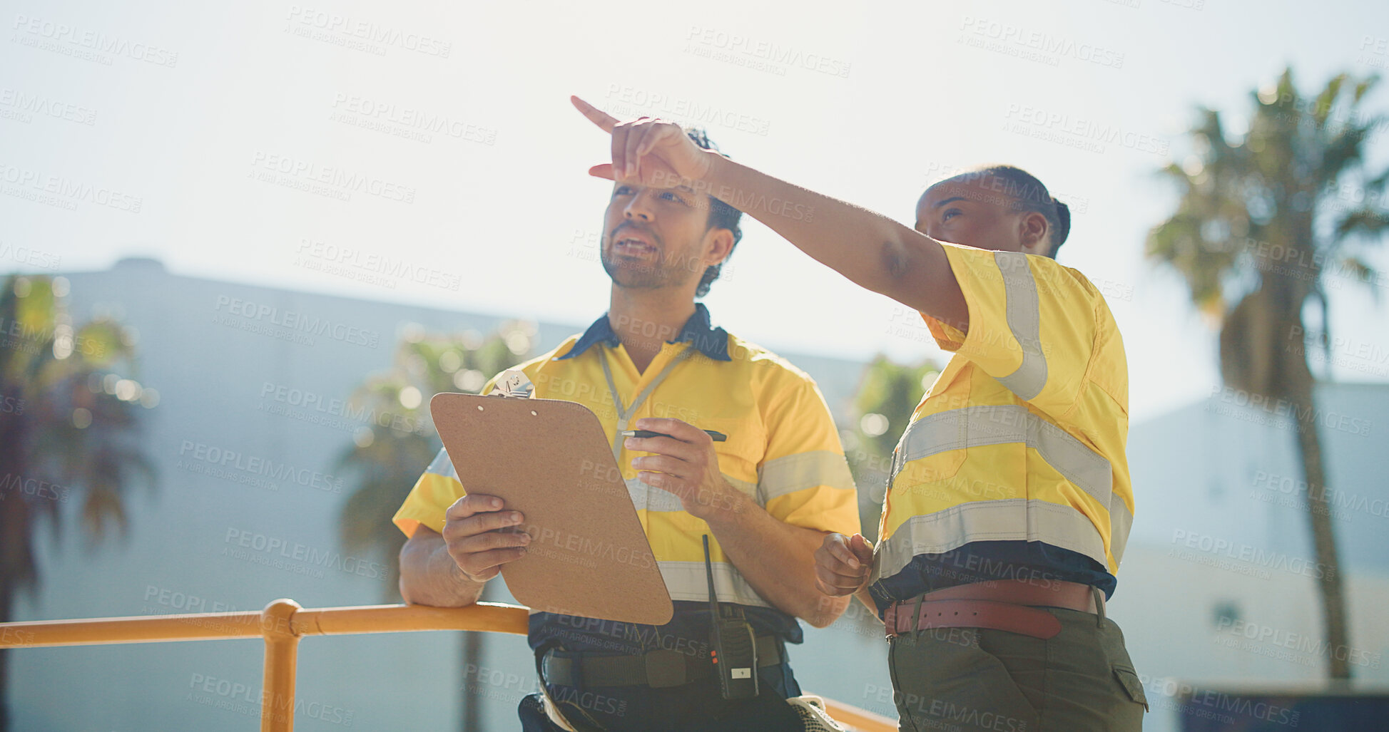 Buy stock photo Warehouse, people outdoor and discussion with clipboard for supply chain, dispatch and shipping. Logistics, coworkers point and talk in cargo zone with checklist for distribution, plan and delivery.