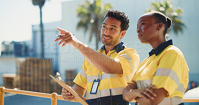 Buy stock photo Logistics, coworkers and outdoor with clipboard for conversation, dispatch or shipping feedback. Supply chain, people and point in cargo zone with checklist for discussion, export or quality control.