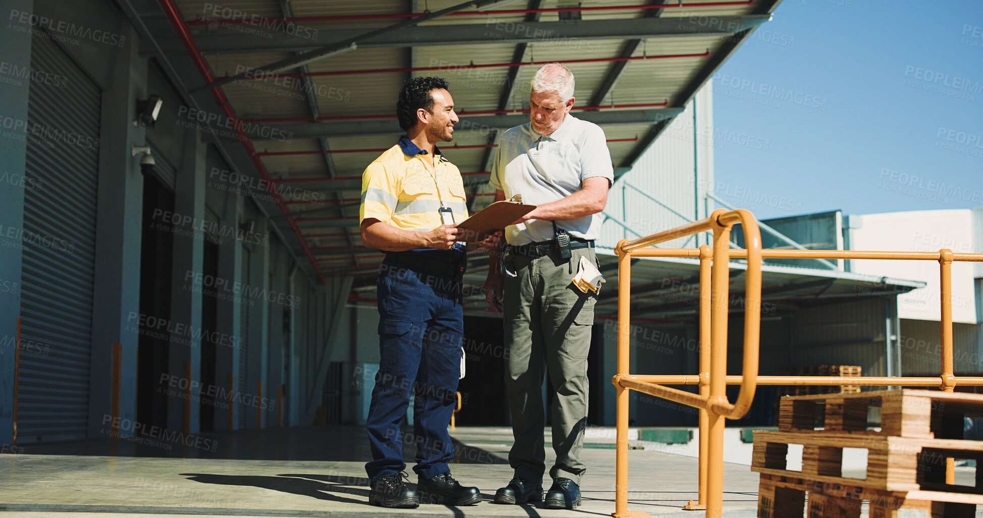 Buy stock photo Warehouse, people outdoor and talking with clipboard for supply chain, dispatch or manager feedback. Team, logistics or discussion at storage facility with checklist, management plan or distribution.