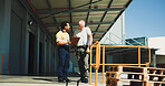 Warehouse, team outdoor and talking with clipboard for supply chain, dispatch or manager feedback. People, logistics or discussion at storage facility with checklist, management plan or distribution.