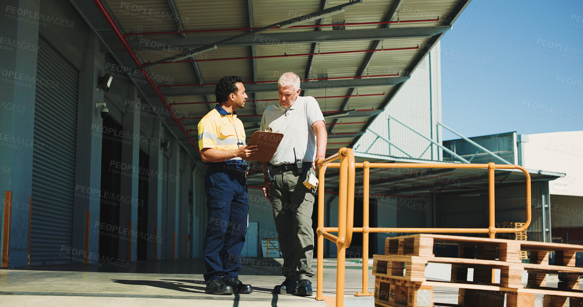 Buy stock photo Warehouse, team outdoor and talking with clipboard for supply chain, dispatch or manager feedback. People, logistics or discussion at storage facility with checklist, management plan or distribution.