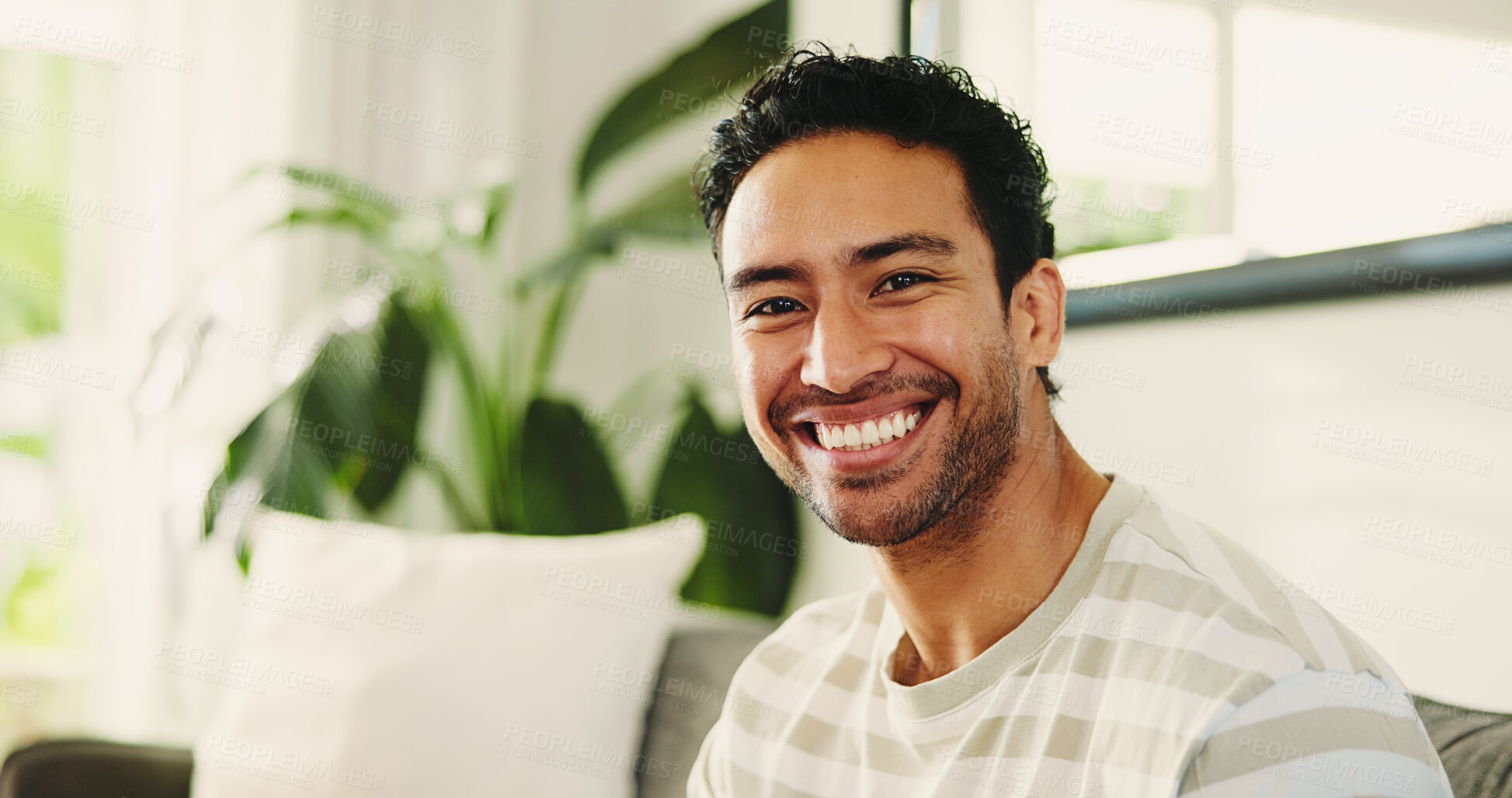 Buy stock photo Man, smile and relax on sofa in portrait, home and pride with confidence, break or rest in lounge. Person, happy and chill on couch, weekend and comfort in living room at apartment in Malaysia