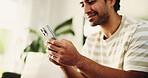 Home, smartphone and man on sofa, typing and social media with communication. Email notification, mobile user and person with cellphone, internet and network with connection, online reading and app