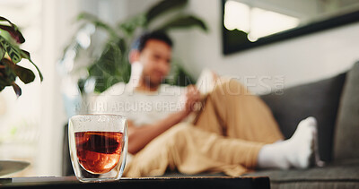 Buy stock photo House, tea and man on sofa, glass cup and relax with weekend break in living room. Apartment, remedy and person on couch, wellness and health with me time, herbal beverage and benefits with vitamins