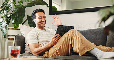 Buy stock photo Man, tablet and video call on sofa, wave and happy with conversation in living room at home. Person, tech and smile with application, virtual chat and hello on web, couch or scroll at apartment