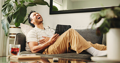Buy stock photo Man, tablet and laugh on sofa, relax and streaming service for funny movies in living room at home. Person, tech and happy with app, video and comedy film on web, couch or subscription at apartment