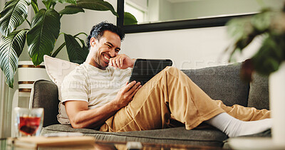 Buy stock photo Man, tablet and laugh on couch, relax and streaming service for funny movies in living room at home. Person, tech and happy with app, video and comedy film on web, sofa or subscription at apartment