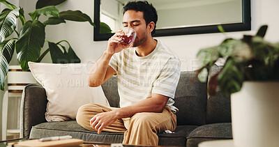 Buy stock photo Man, relax and herbal tea with glass on sofa for cool beverage, thirst or refreshment in home. Male person, chilling and rest with drink or comfort for healing remedy, vitamins or nutrition in house
