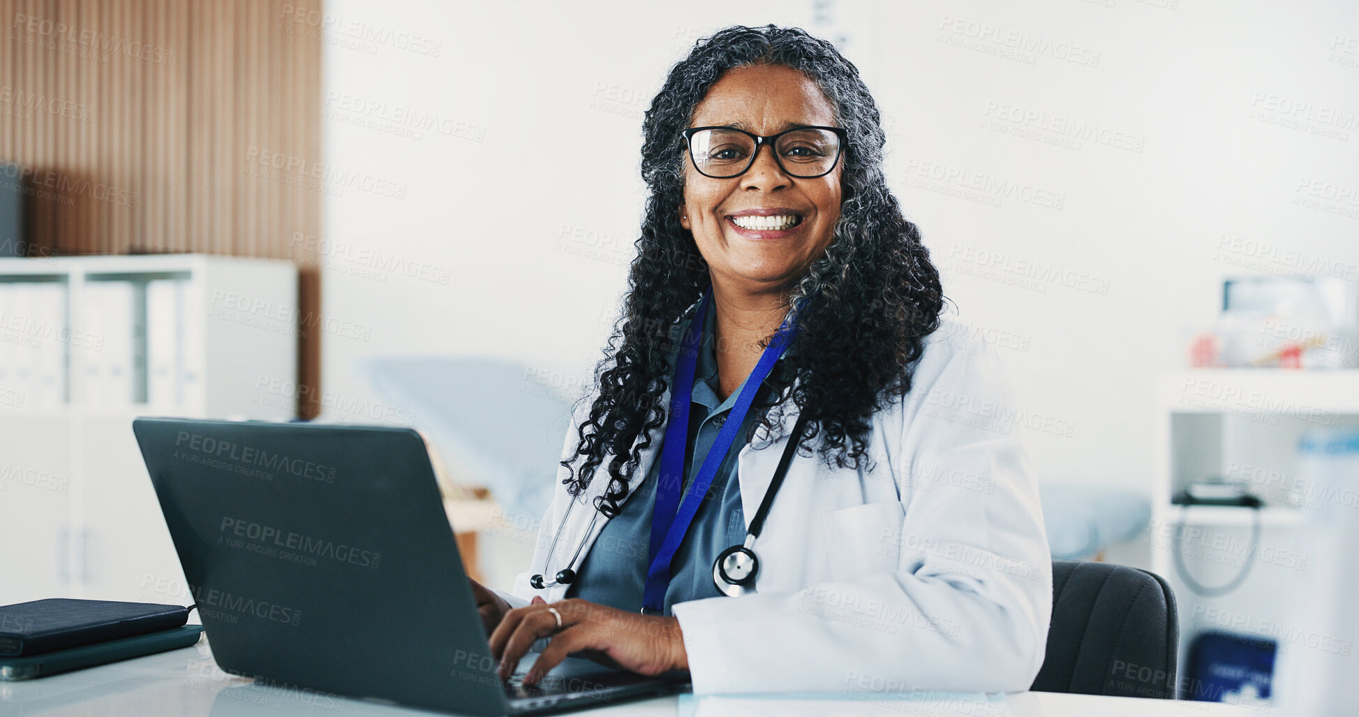 Buy stock photo Smile, black woman and portrait of doctor with laptop for medical, healthcare or admin in office. Cardiologist, mature person and tech with clinic schedule, telehealth or research for service