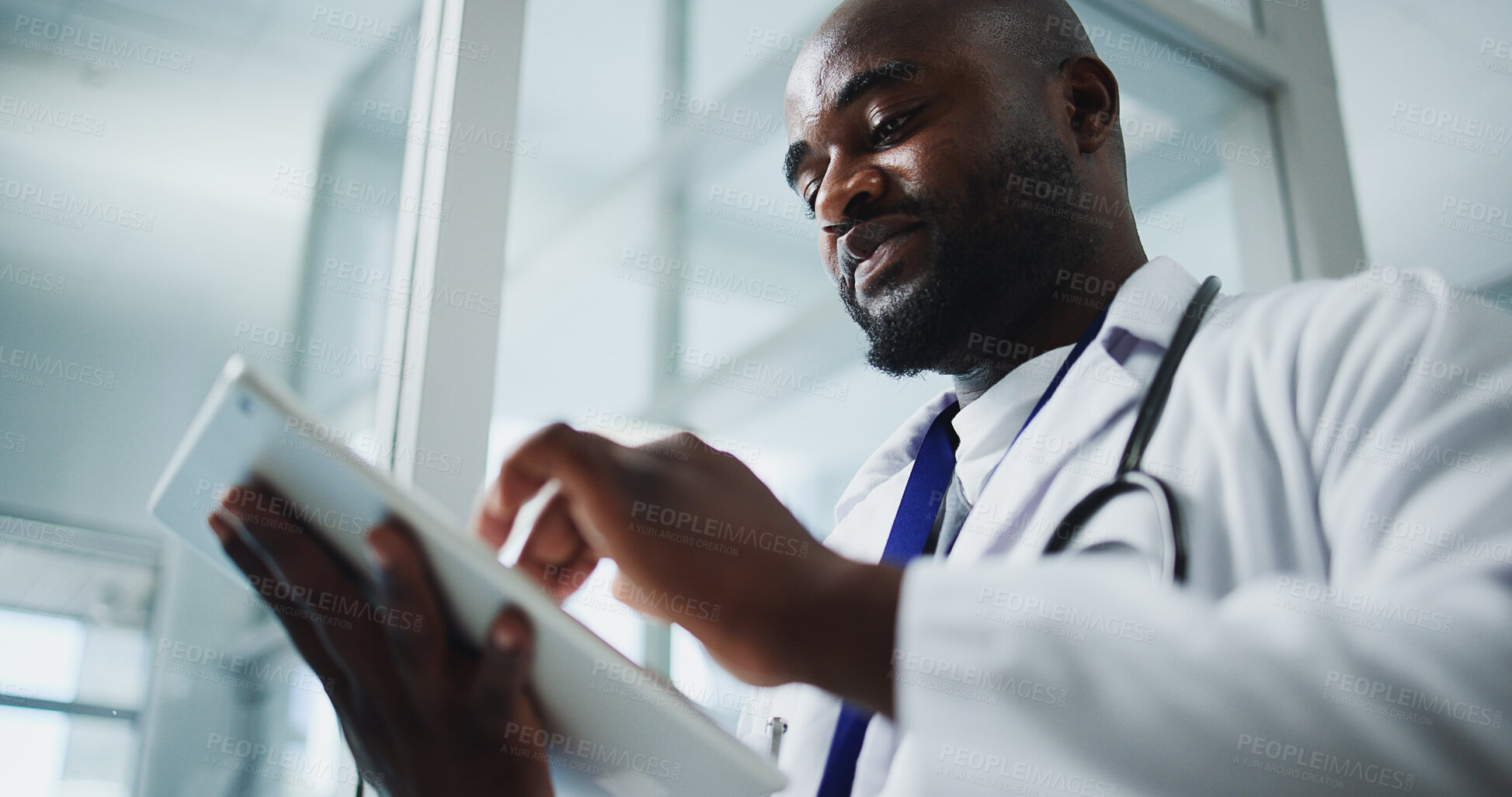 Buy stock photo Below, black man and doctor reading with tablet for research, medical report and test results. Male person, hospital and digital with healthcare information, treatment planning and surgery feedback