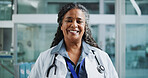 Happy woman, doctor and portrait in clinic for healthcare, about us and friendly service. Mature cardiologist, smile and black person in hospital with experience, medical consultation and integrity
