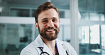 Happy, medical and portrait of doctor in hospital with confidence for healthcare career. Smile, professional service and male surgeon with pride for support or expert help in lobby at clinic.