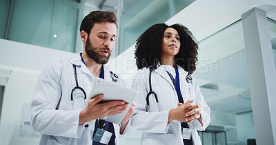 Buy stock photo Tablet, team and doctors in hospital with research for medical service or surgery schedule. Telehealth, technology and healthcare worker in discussion with patient information in clinic from below.