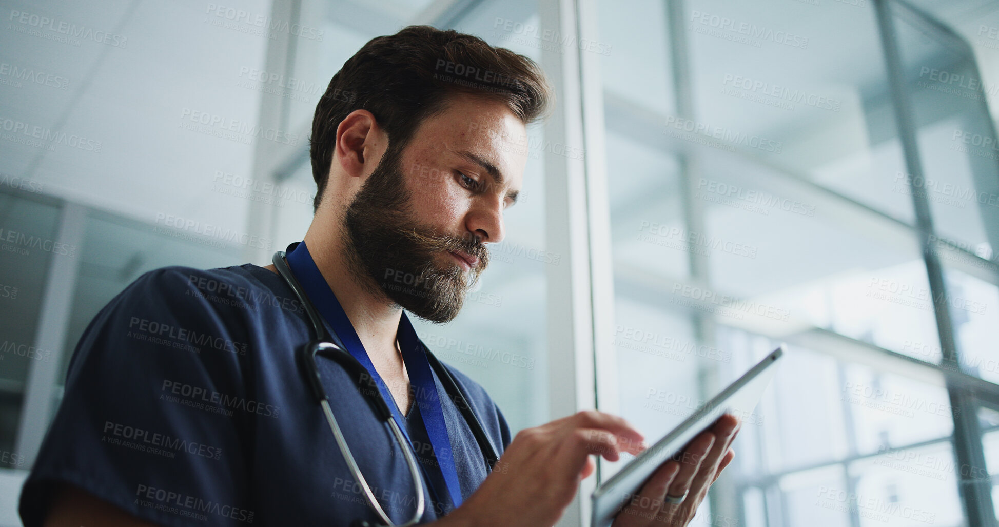 Buy stock photo Man, nurse and reading with tablet in hospital for research, medical report and telehealth. Male person, browsing and digital with healthcare information, treatment planning and schedule for surgery