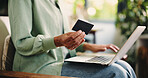 Credit card, laptop and hands of woman on sofa in home for online shopping, banking app and ecommerce. Digital transaction, customer experience and fintech with person in living room of apartment