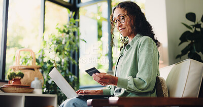 Buy stock photo Credit card, laptop and reading with woman on sofa in home for online shopping, banking app and ecommerce. Digital transaction, customer experience and fintech with mature person in living room