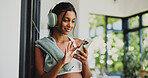 Scroll, smartphone and woman with headphones, home and texting with tech, wellness and social media. Fitness, athlete and Indian person with mobile for chat, space and subscription for music in house