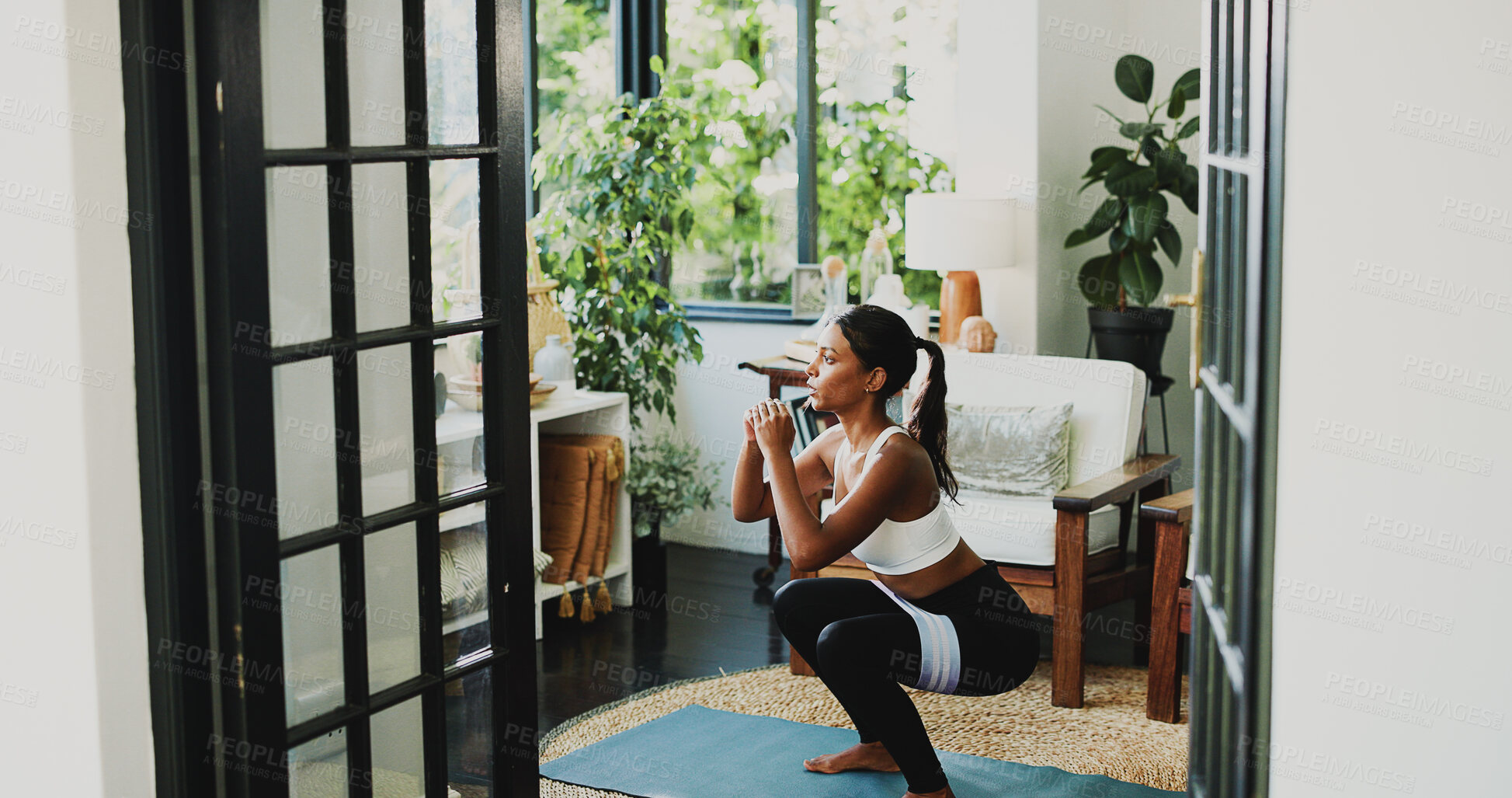 Buy stock photo Squat, fitness and health with woman in home for workout, glute growth development or challenge. Exercise, wellness and muscle with person in living room of apartment for training and resistance band