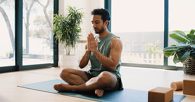 Buy stock photo Mindfulness, yoga and man in home, namaste and meditation for inner peace, calm and wellness on mat. Zen, person and spiritual awareness for mental health, yogi and prayer hands for stress relief