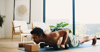 Buy stock photo Fitness, man and push up in home with weights for balance exercise, strength training or bodybuilding. Active, person and dumbbells in apartment with workout for stability, endurance and performance.