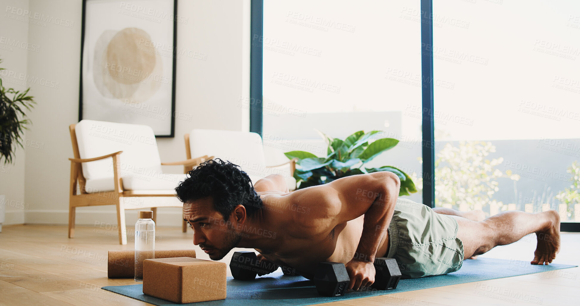 Buy stock photo Fitness, man and push up in home with weights for balance exercise, strength training or bodybuilding. Active, person and dumbbells in apartment with workout for stability, endurance and performance.