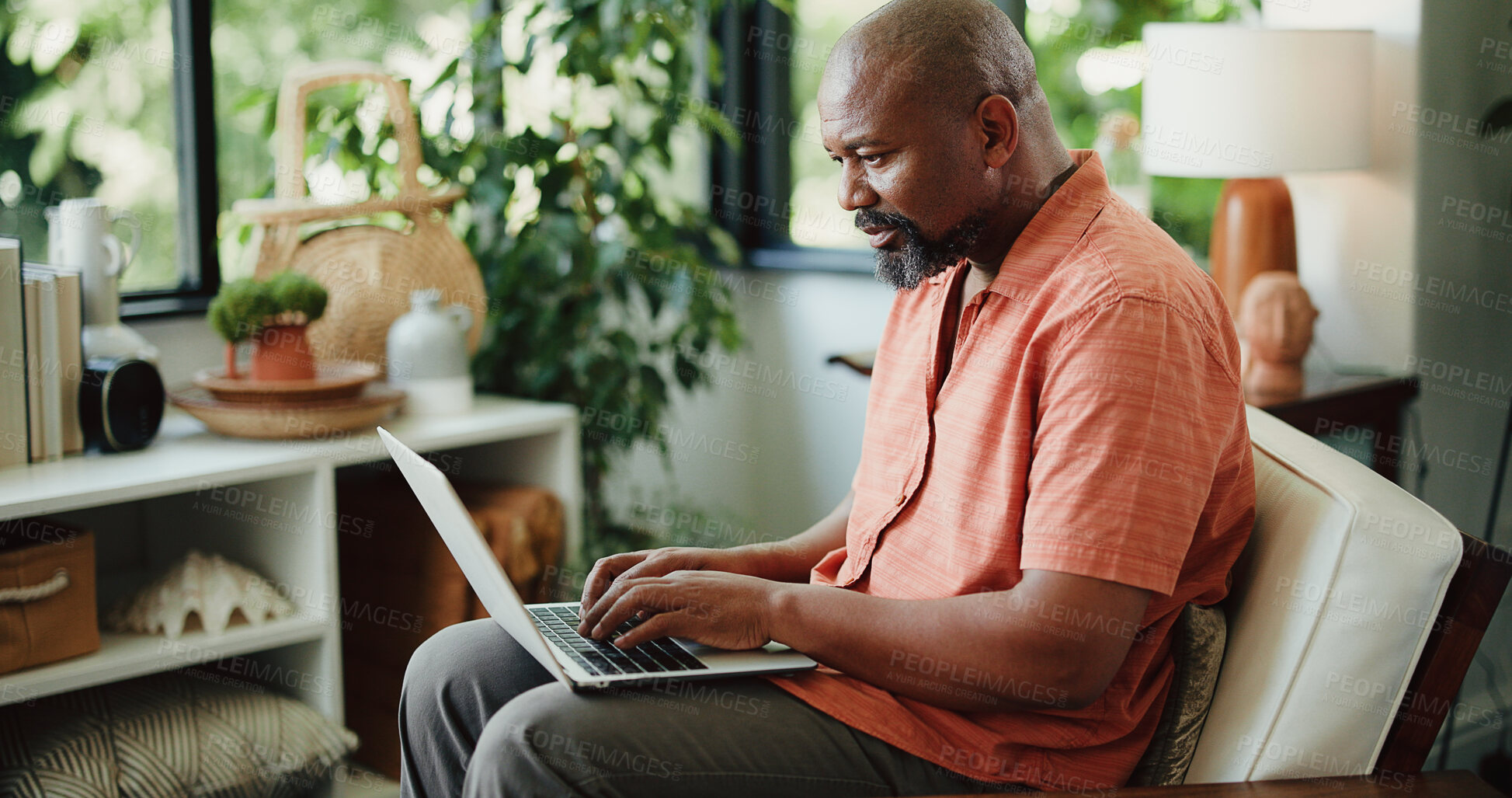 Buy stock photo Remote work, typing or journalist in house with laptop, insight or edit of news article. Freelancer, mature or black man in home with tech, proofreading or fact check for digital publication.