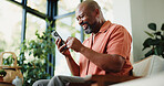 Lounge, reading or happy man with phone in home, internet search or scroll social media from low angle. Smile, funny blog or mature black person with mobile for forum discussion, comic story or app