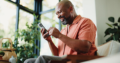 Buy stock photo Lounge, reading or happy man with phone in home, internet search or scroll social media from low angle. Smile, funny blog or mature black person with mobile for forum discussion, comic story or app