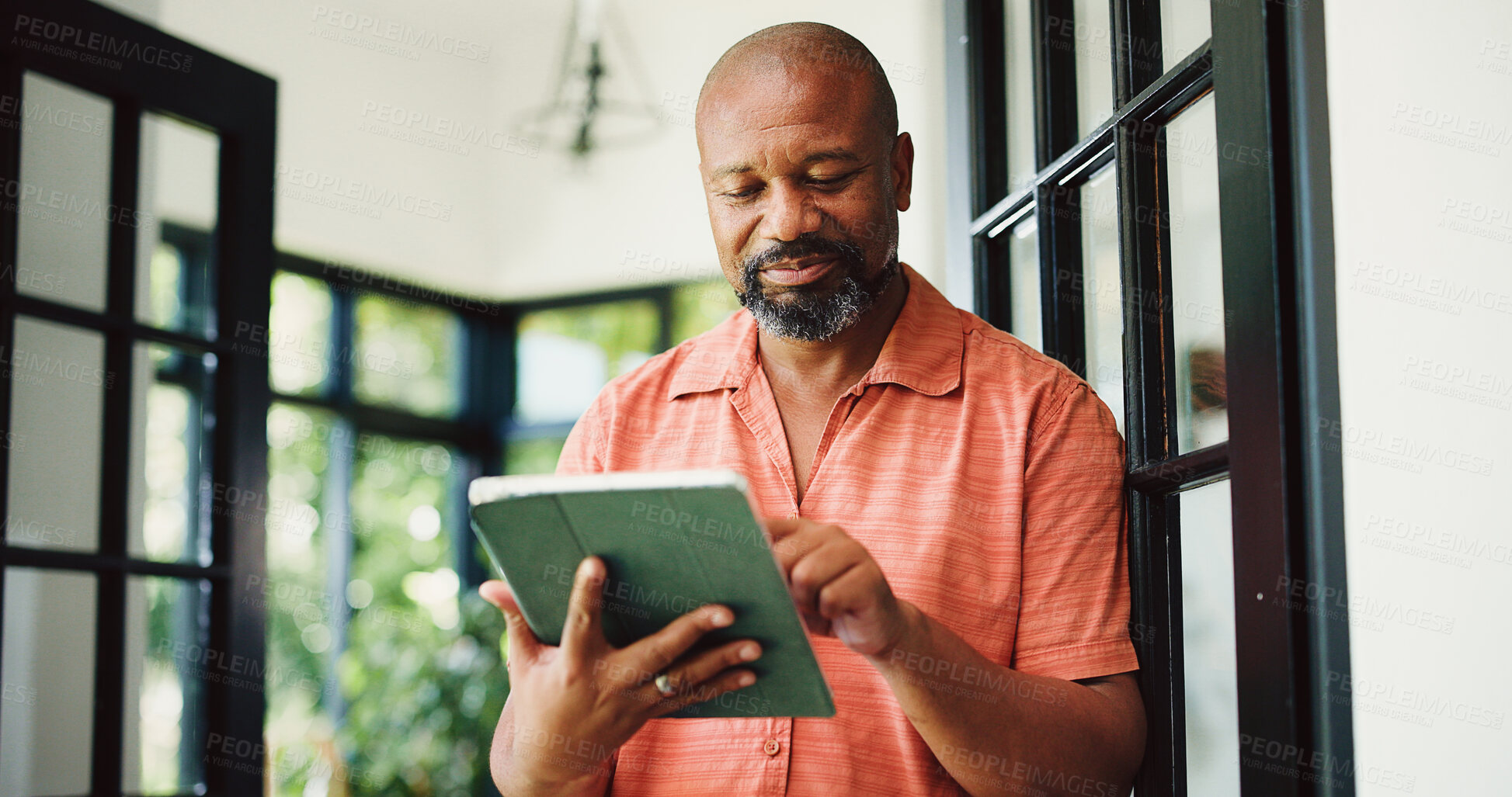 Buy stock photo Typing, home and mature black man on tablet for internet, subscription and website for contact. House, communication and person on digital tech for networking, online email and connection for news