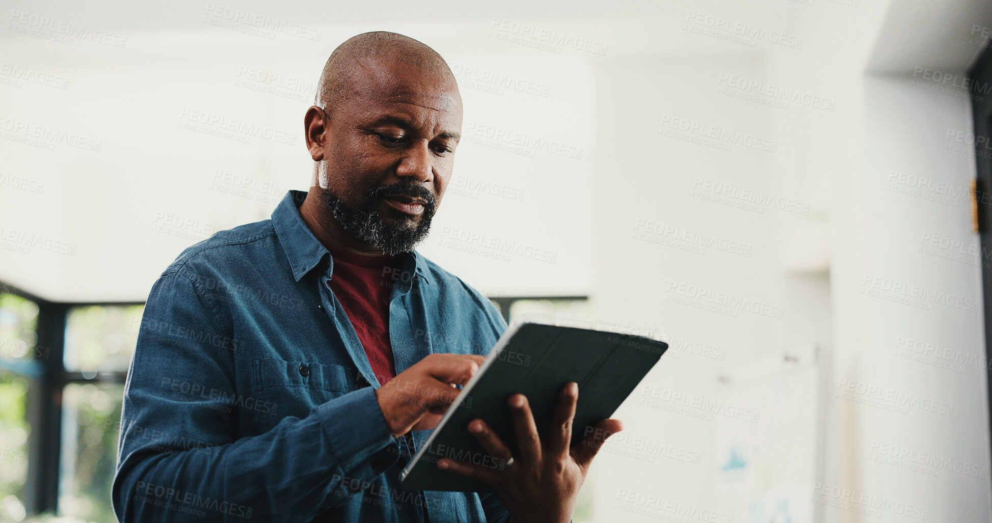 Buy stock photo Web designer, black man or reading with tablet in home, site optimization or check homepage features. Review project, freelance or mature person with domain update, tech or planning of brand identity