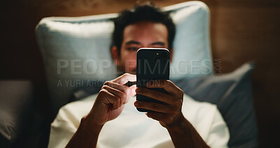 Buy stock photo Night, man and hands in bed with phone for text message reply, social media and watching viral video. Late, person and scroll with tech in apartment for online conversation, internet and mobile app.
