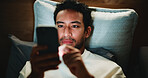 Night, man and scroll in bedroom with phone for text message reply, social media and watching video. Late, person and browse with tech in apartment for online conversation, internet and mobile app.