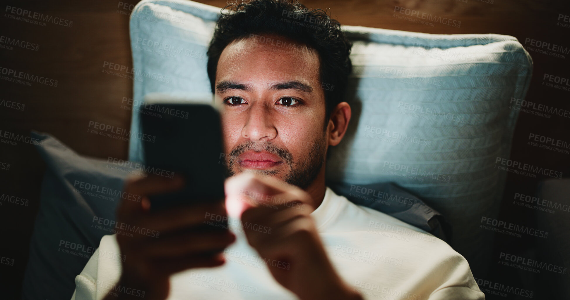 Buy stock photo Night, man and scroll in bedroom with phone for text message reply, social media and watching video. Late, person and browse with tech in apartment for online conversation, internet and mobile app.