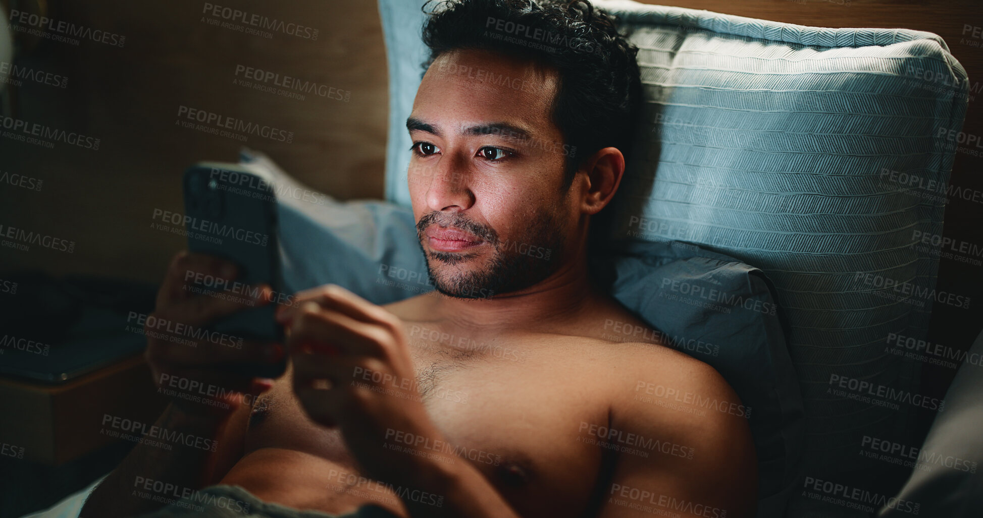 Buy stock photo Night, man and typing in bed with phone for text message reply, social media and check dating site. Late, person and browsing with tech in apartment for online conversation, internet and mobile app.