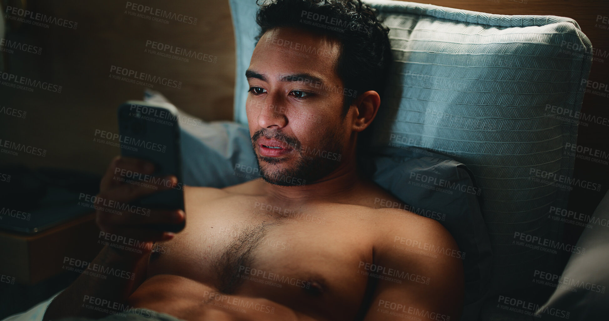 Buy stock photo Home, smartphone and man in bedroom, night and relax with blue light exposure. Apartment, mobile user and Asian person with cellphone, evening and social media with internet, scroll or online reading