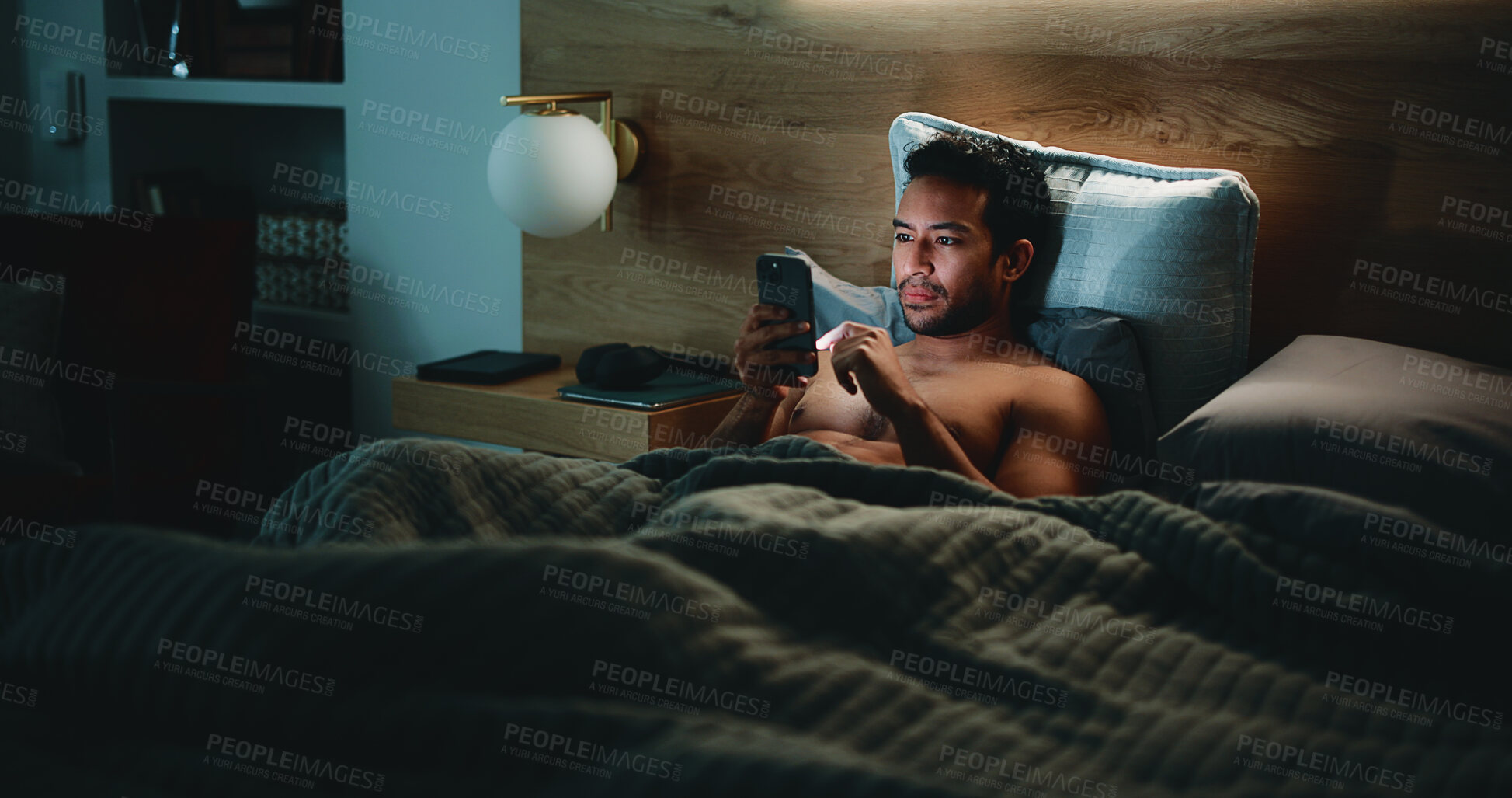 Buy stock photo Night, man and check phone in bedroom for text message reply, social media or dating site notification. Late, person and scroll with tech in apartment for online conversation, internet or mobile app.