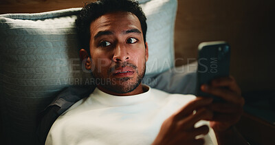 Buy stock photo Night, surprise and man with phone in bedroom, watch horror movie and loud noise for fear reaction. Shock, suspicious sound and person in dark home with mobile for film streaming, worry and paranoid