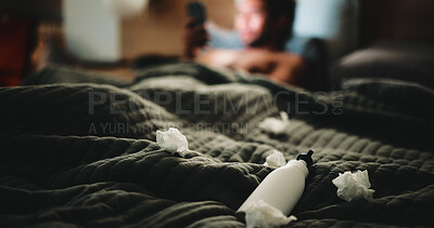 Buy stock photo Tissue, lubricant and masturbation on bed in home, person and phone for adult content addiction. Tech, smartphone and night with bottle, personal pleasure and scroll with online temptation at house