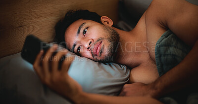 Buy stock photo Night, man and relax in bed with phone for text message reply, social media and reading news update. Late, person and scroll with tech in apartment for online conversation, internet and mobile app.