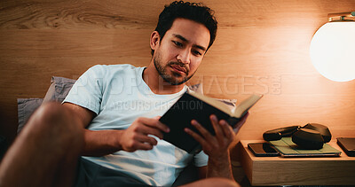 Buy stock photo Reading, novel and man in bed at night in home with relax for hobby, knowledge or entertainment. Calm, late and male person in bedroom with fiction story, book or literature on weekend in apartment.