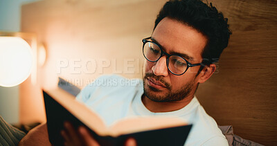 Buy stock photo Reading book, evening and man in bed, glasses and comfortable with entertainment. Night, eyewear and person with novel, house and hobby with cozy activity, literature and fiction story with poetry
