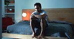 Night, lonely and man thinking with depression, mental health or insomnia from sad memories in bedroom. Late, contemplation or anxious person with grief, worry and sleepless from stress in apartment.