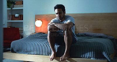 Buy stock photo Night, lonely and man thinking with depression, mental health or insomnia from sad memories in bedroom. Late, contemplation or anxious person with grief, worry and sleepless from stress in apartment.